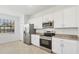 Modern kitchen with stainless steel appliances, granite countertops, and lots of cabinet space at 1602 Saddlewood Cir, Port Charlotte, FL 33953