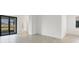 Open-concept living space with tiled flooring and sliding glass doors, leading to the lanai and bathroom at 1602 Saddlewood Cir, Port Charlotte, FL 33953
