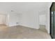 Spacious living area with neutral walls, tiled flooring, and an open doorway leading to other rooms at 1602 Saddlewood Cir, Port Charlotte, FL 33953