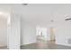 Bright and airy living area leading to an open kitchen with white cabinets and granite countertops at 1602 Saddlewood Cir, Port Charlotte, FL 33953