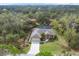 An aerial view of the house with a screened pool and a well maintained yard at 16229 Edile Ave, Port Charlotte, FL 33954