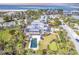 Luxury estate boasts a pool, putting green, and manicured grounds near the ocean at 16250 Sunset Pines Cir, Boca Grande, FL 33921