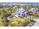 Coastal home with private pool, putting green, and beach access, surrounded by tropical landscaping at 16250 Sunset Pines Cir, Boca Grande, FL 33921