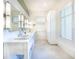 Elegant bathroom featuring dual sinks, modern lighting, and ample storage space at 16250 Sunset Pines Cir, Boca Grande, FL 33921