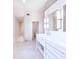 Bright bathroom with a walk-in shower, double sinks, and white cabinetry at 16250 Sunset Pines Cir, Boca Grande, FL 33921