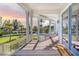 Inviting deck with elegant columns and a view of the putting green and pool at 16250 Sunset Pines Cir, Boca Grande, FL 33921