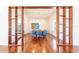 Dining room framed by wooden shelving, featuring hardwood floors, modern lighting, and comfortable seating at 16250 Sunset Pines Cir, Boca Grande, FL 33921