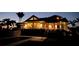 Stunning waterfront home exterior at twilight with a private pool and illuminated windows at 16250 Sunset Pines Cir, Boca Grande, FL 33921