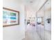 Hallway leading to a bedroom with mirrored closet doors and coastal artwork at 16250 Sunset Pines Cir, Boca Grande, FL 33921