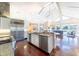 Bright, open kitchen with stainless appliances and island overlooking the living area at 16250 Sunset Pines Cir, Boca Grande, FL 33921