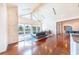 Spacious living room with vaulted ceilings, hardwood floors, and large windows offering scenic views at 16250 Sunset Pines Cir, Boca Grande, FL 33921
