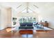 Bright living room with fireplace, vaulted ceilings, hardwood floors, and large windows at 16250 Sunset Pines Cir, Boca Grande, FL 33921