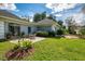 Charming backyard patio area with seating, surrounded by well-manicured lawn and lush greenery at 17 Dominica Dr, Englewood, FL 34223