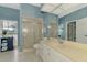 Bathroom featuring a large vanity, a large mirror, blue walls, and a shower with sliding glass doors at 17 Dominica Dr, Englewood, FL 34223