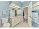 Bathroom featuring a vanity with white cabinets, a toilet, and decorative towels at 17 Dominica Dr, Englewood, FL 34223