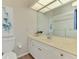 Bathroom featuring double sinks with a large mirror and a shower with glass doors at 17 Dominica Dr, Englewood, FL 34223