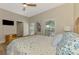Bedroom featuring hardwood floors, a ceiling fan, and a window overlooking a green space at 17 Dominica Dr, Englewood, FL 34223