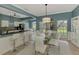 Bright dining room with blue walls and white trim, with view to kitchen and bar seating at 17 Dominica Dr, Englewood, FL 34223