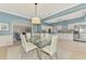 Bright dining room with blue walls and white trim, with view to kitchen and the main living area at 17 Dominica Dr, Englewood, FL 34223