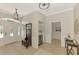 Open entryway with tile flooring, coat rack, and a glimpse into the living spaces at 17 Dominica Dr, Englewood, FL 34223