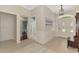 Bright and airy entryway featuring tile flooring, a view of the bedroom and a decorative painting on the wall at 17 Dominica Dr, Englewood, FL 34223
