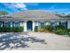Charming house with gray roof, blue shutters, lush landscaping, and a spacious driveway for parking at 17 Dominica Dr, Englewood, FL 34223