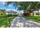 Beautiful single-story home featuring a large, inviting driveway and mature landscaping and manicured lawn at 17 Dominica Dr, Englewood, FL 34223