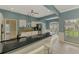 Charming kitchen featuring granite counters, white cabinets, a breakfast bar, and stainless steel appliances at 17 Dominica Dr, Englewood, FL 34223