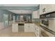 A view of the large kitchen with granite countertops and stainless steel appliances at 17 Dominica Dr, Englewood, FL 34223