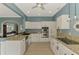 A view of the large kitchen showcasing white cabinets, granite countertops, and stainless steel appliances at 17 Dominica Dr, Englewood, FL 34223