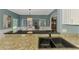 A modern kitchen with a sink and granite countertop at 17 Dominica Dr, Englewood, FL 34223