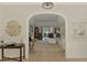 Open-concept living space with tile flooring, archway, wainscoting, comfortable furniture, and backyard view at 17 Dominica Dr, Englewood, FL 34223