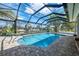 Gorgeous pool with a screened enclosure, waterfront views and lush landscaping for privacy at 17 Dominica Dr, Englewood, FL 34223