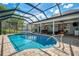 Stunning screened-in pool with a water feature and spacious patio for outdoor relaxation and entertaining at 17 Dominica Dr, Englewood, FL 34223