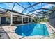 Stunning screened pool with brick trim, complemented by a covered patio and exterior door access at 17 Dominica Dr, Englewood, FL 34223