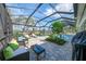 Relaxing screened-in pool patio with lush landscaping, offering a serene retreat for relaxation and leisure at 17 Dominica Dr, Englewood, FL 34223