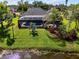 The screened-in pool in the backyard offers a private retreat, complemented by well-kept landscaping and a lake view at 17 Dominica Dr, Englewood, FL 34223