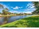 Breathtaking water view of a peaceful canal, framed by vibrant green grass and mature trees at 17 Dominica Dr, Englewood, FL 34223