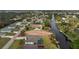 Aerial view of a home on canal with a screened lanai overlooking the waterway at 184 Eppinger Dr, Port Charlotte, FL 33953