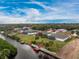 Beautiful canal front property featuring a private dock and a screened pool, surrounded by lush landscaping and serene waterfront views at 184 Eppinger Dr, Port Charlotte, FL 33953