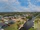 Expansive aerial view of home on canal with a screened lanai, lush lawn, and private dock at 184 Eppinger Dr, Port Charlotte, FL 33953