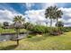 Beautiful backyard with lush landscaping, dock, and scenic waterfront views at 184 Eppinger Dr, Port Charlotte, FL 33953