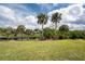 Backyard with lush landscaping, dock, and scenic waterfront views, ideal for outdoor enjoyment at 184 Eppinger Dr, Port Charlotte, FL 33953