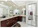 Well-lit bathroom boasts a large mirror, double sink vanity, and tile flooring at 184 Eppinger Dr, Port Charlotte, FL 33953