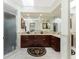 Bright bathroom features a large mirror, double sink vanity, and glass enclosed shower at 184 Eppinger Dr, Port Charlotte, FL 33953