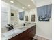 Spacious bathroom features a large mirror, granite vanity, and window with curtains at 184 Eppinger Dr, Port Charlotte, FL 33953