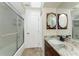 Bathroom features a single sink vanity with granite counters and a glass-enclosed shower at 184 Eppinger Dr, Port Charlotte, FL 33953