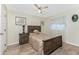 Neutral bedroom with a wood bed frame, tile flooring, and natural light at 184 Eppinger Dr, Port Charlotte, FL 33953