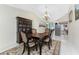 Traditional dining room featuring a dark wood table, china cabinet, chandelier and tiled floors at 184 Eppinger Dr, Port Charlotte, FL 33953