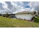 Back of the house with a screened-in pool, well-manicured lawn, and lush landscaping at 184 Eppinger Dr, Port Charlotte, FL 33953
